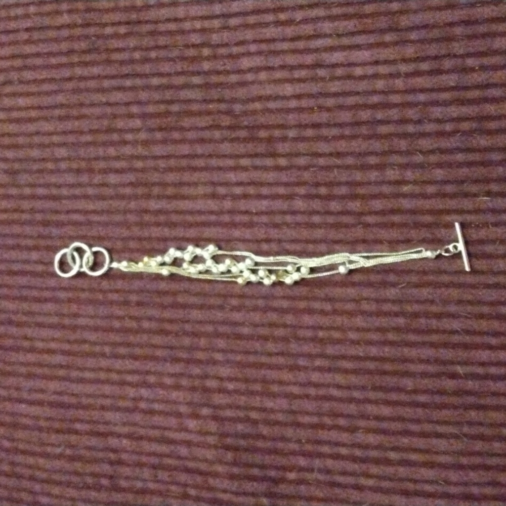 Silver adjustable toggle bracelets with silver balls on.